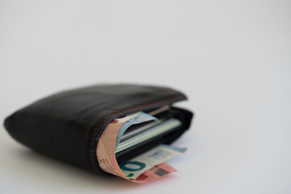 Close-up of a leather wallet filled with Euro banknotes on a white background, perfect for financial and lifestyle themes.